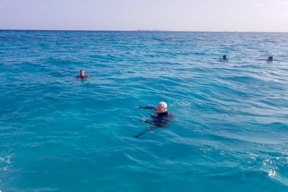 Snorkelers exploring the water above Manchones Reef