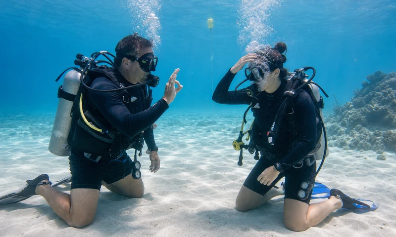 Scuba instructor supervising a student practicing mask clearing in Isla Mujeres
