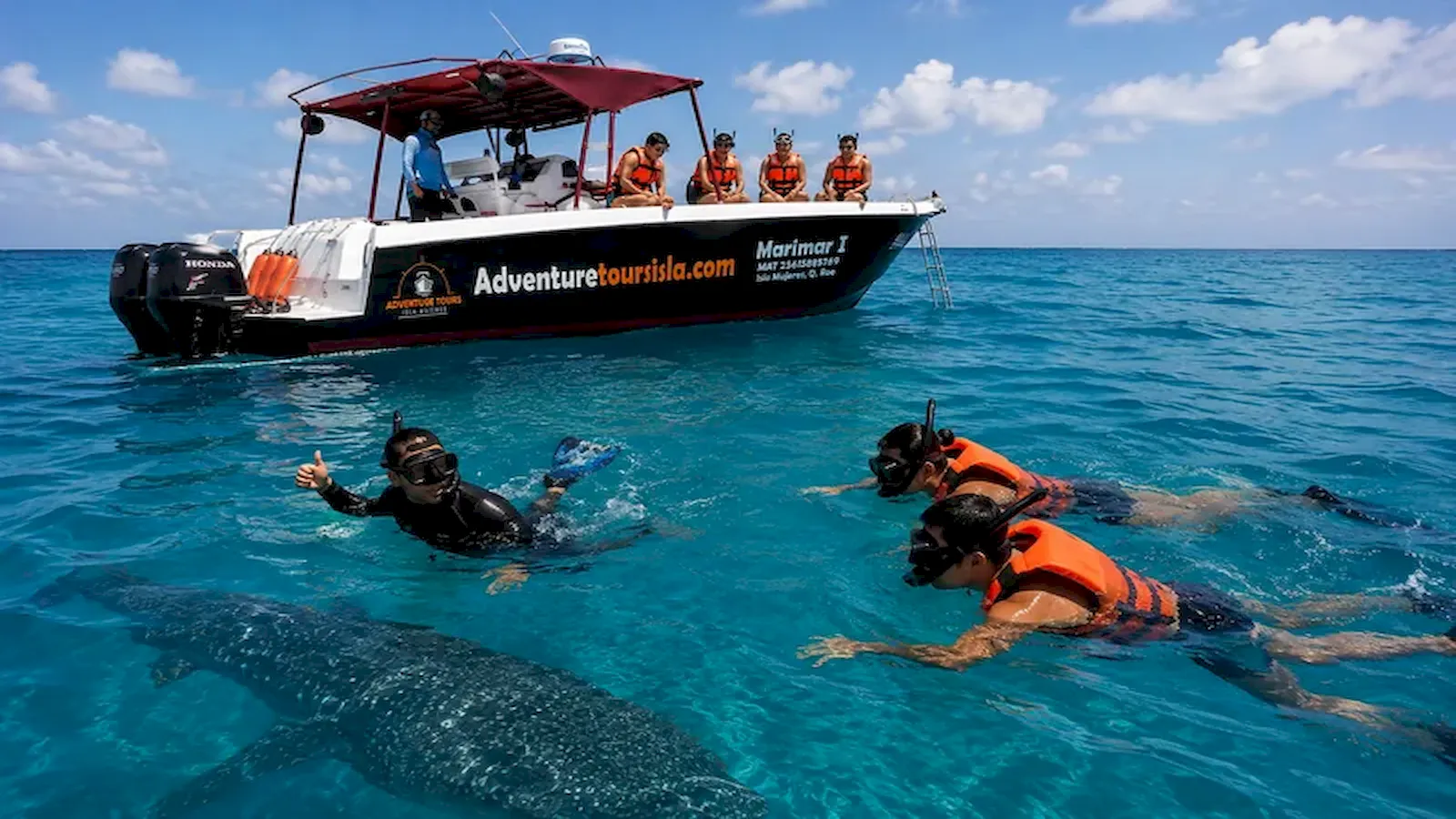 Adventure Tours Isla Mujeres boat and snorkelers during whale shark season