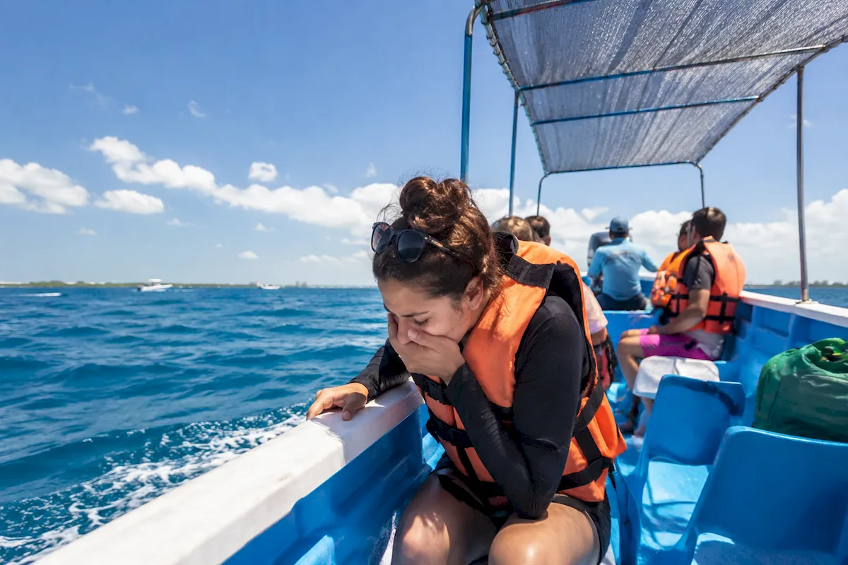 Traveler managing seasickness aboard a boat