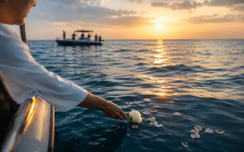 Family sharing a quiet moment during a private memorial at sea